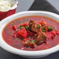 Russian Borshct · Russian - Ukrainian soup chunks of beef, vegetables and red beets served with sour cream.