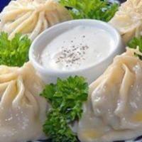 Handmade Manti · 4 pieces. Large steamed dumplings stuffed with hand cut steak and onion makes it juicy, serv...