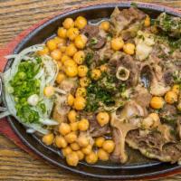 Ox Tail Stew · Slowly braised with chickpeas, onions, topped with  onions and fresh herbs.