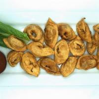 Chuchvara · Handmade crispy or boiled mini beef dumplings served with caramelized onion and sour cream o...