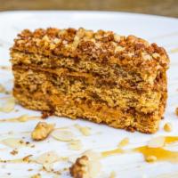 Mom'S Honey Cake · Soft honey cake layered with caramel filling topped with walnuts and chocolate.