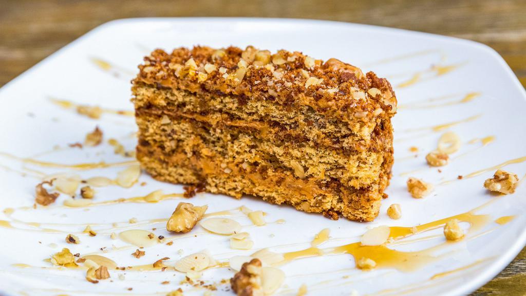 Mom'S Honey Cake · Soft honey cake layered with caramel filling topped with walnuts and chocolate.