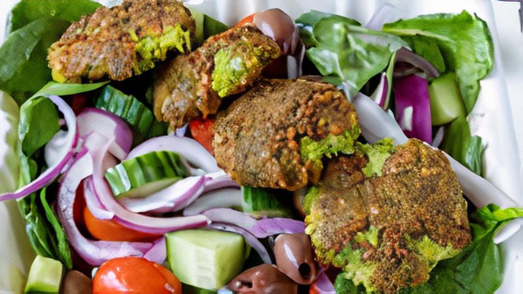 Greek Vegan Salad · Greek Vegan Salad - Spinach, Grape Tomatoes, Red Onions, Kalamata Olives, Falafel, Cucumbers with Red Wine Vinaigrette