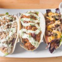 Tacos · 2 soft shell corn tortillas filled with your choice of beef, chicken or chili. Includes lett...