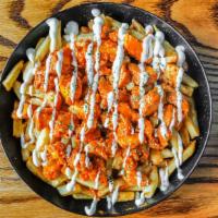 Buffalo Chicken Fries · Buffalo Chicken pieces over fries and spicy sauce.