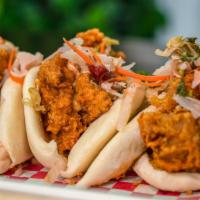 Fried Chicken Baos · Seasoned fried chicken, house sauce, and curtido 