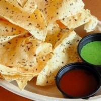Chips And Chutney · Papadum chips made with chickpea lentil and rice flour. Served with our signature cilantro-m...