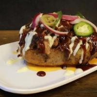 Pulled Beef Potato · Pulled Beef on a baked potato topped with pickled jalapeno, red onion, Garlic aioli & bbq sa...
