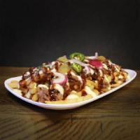 Smoked Brisket Loaded Fries · Smoked brisket on crispy fries, topped with pickled jalapenos, red onion, garlic aioli, BBQ ...