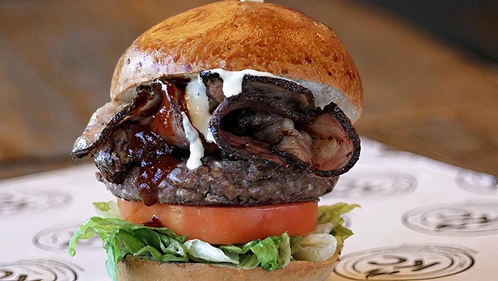 Lower East Side Pastrami Burger · Lettuce, tomato, Grilled Pastrami, Barbeque sauce & Garlic Aioli.