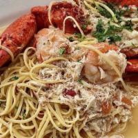 Jewels Of The Sea · Half lobster and crab meat, grape tomato garlic white wine sauce over linguine.