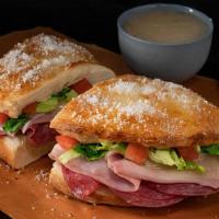 Italian Deli Boat · Calzone style sandwich baked with pizza dough stuffed with ham, salami, provolone, lettuce &...