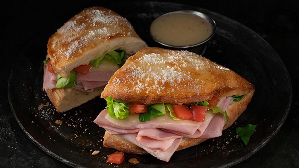 Ham And Cheese Deli Boat · Calzone style sandwich baked with pizza dough stuffed with ham, provolone, lettuce & tomatoes. Served with a side of Italian dressing. (10