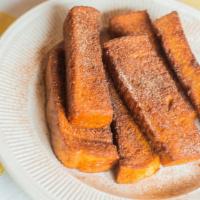 Deep-Fried French Toast Sticks · Homemade french toast cut into sticks, deep fried and rolled in cinnamon sugar.