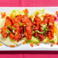 Chicken 65 · Spicy chicken cubes sauteed with onion and bell peppers in hot sauce.
