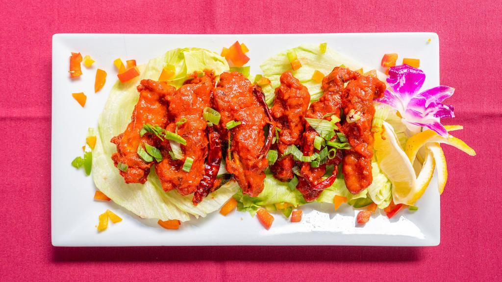 Chicken 65 · Spicy chicken cubes sauteed with onion and bell peppers in hot sauce.
