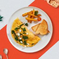 Cheesy Spinach Omelette · Eggs cooked with spinach, feta cheese, onion, and tomatoes as an omellete. Served with your ...