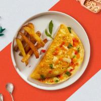 Golden Girl Omelette · Eggs cooked with tomatoes, onion, peppers and American cheese as an omellete. Served with yo...