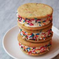 Confetti Cake Ice Cream Sandwich · Confetti cookies, light lemon buttercream, vanilla ice cream, and rainbow sprinkles.