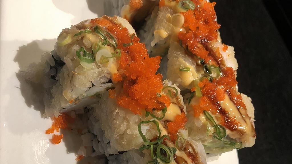 Dynamite Roll · Spicy yellowtail, spicy salmon, and avocado wrapped inside, topped with lobster salad and tobiko.
