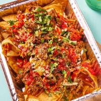Birria Loaded Nacho Chips · Crispy and crunchy homemade corn tortilla chips topped with tender Birria beef, spanish onio...