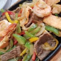 Signature Fajitas With Mixed Meats · Steak, chicken, shrimps, sautéed bell peppers and onions, saffron yellow rice, black beans a...