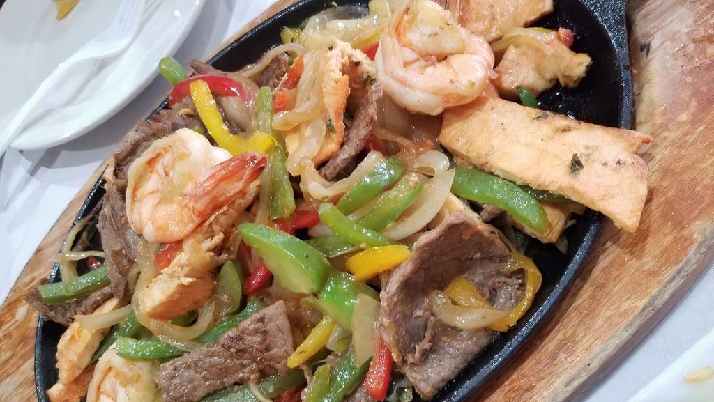 Signature Fajitas With Mixed Meats · Steak, chicken, shrimps, sautéed bell peppers and onions, saffron yellow rice, black beans and flour tortillas.