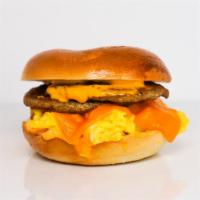 Bagel, Sausage, Egg, & Cheddar Sandwich · 2 scrambled eggs, melted Cheddar cheese, breakfast sausage, and Sriracha aioli on a toasted ...