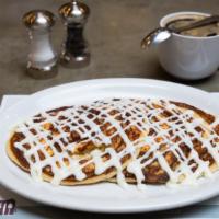 Cinnamon Roll Pancakes · Cinnamon sweet swirls topped with cream cheese frosting .