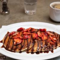Berry Chocolaty · Chocolate chip pancakes, fresh strawberries, chocolate drizzle.