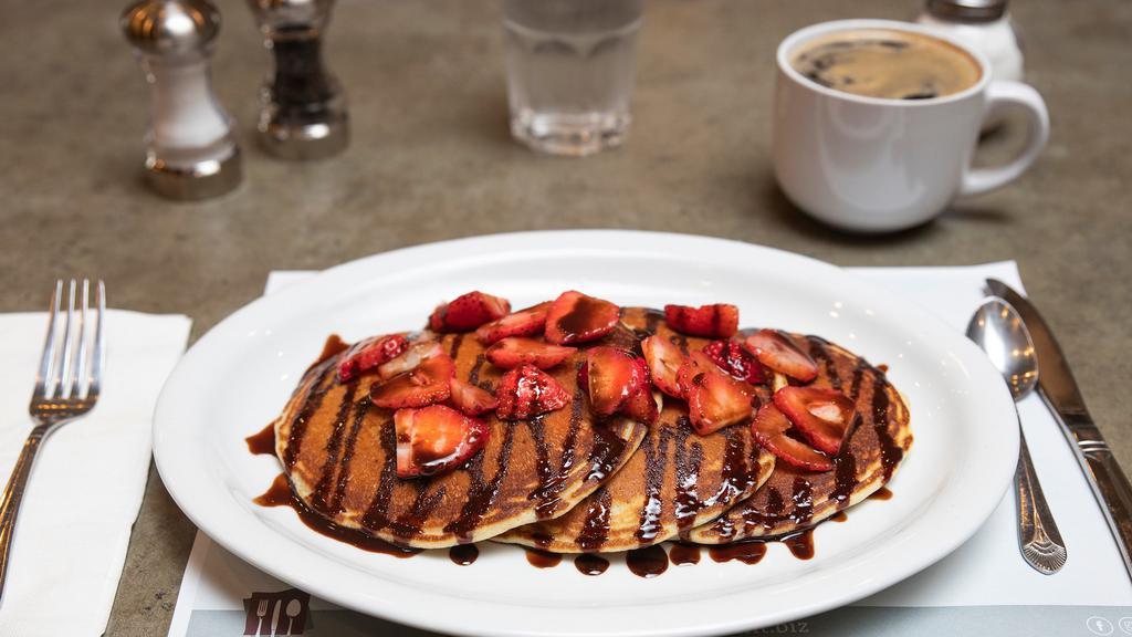 Berry Chocolaty · Chocolate chip pancakes, fresh strawberries, chocolate drizzle.