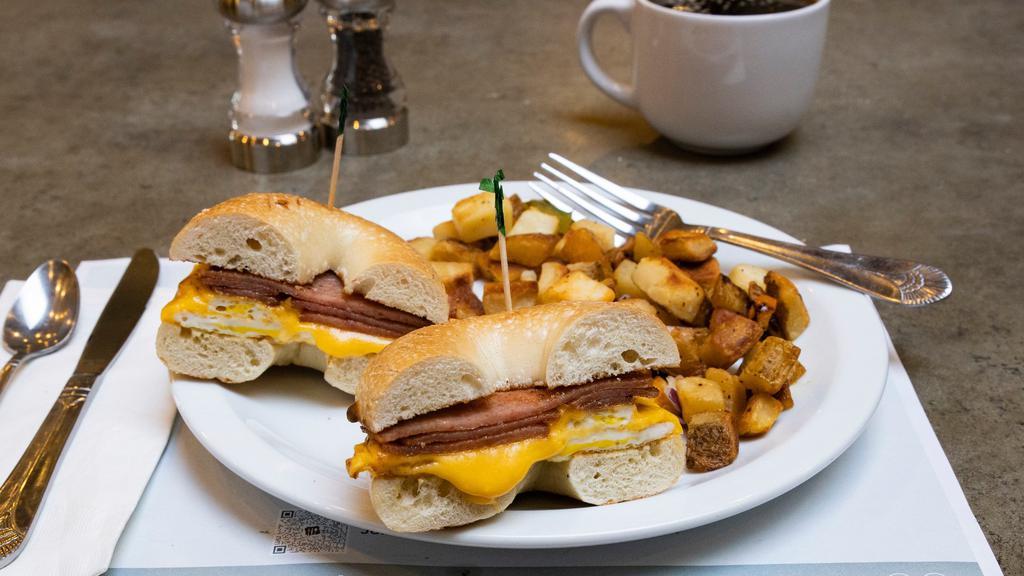 Classic Pork Roll Sammy · Toasted plain bagel, loaded with grilled Taylor pork roll, two over hard eggs & American cheese with side of potatoes or citrus dressed greens (1160-1300 cal).