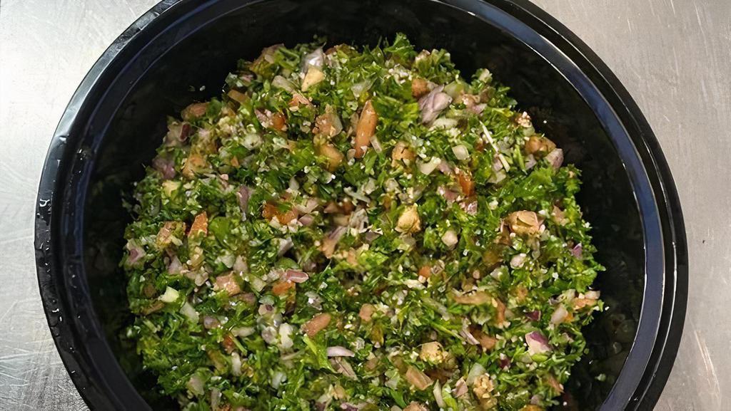 Tabouli Salad · Curly parsley, tomatoes, red onions, with olive oil. & lemon juice topped with bulgur wheat.