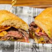 Steak Sandwich · Marinated skirt steak, guacamole, pickled onions & bbq chips
