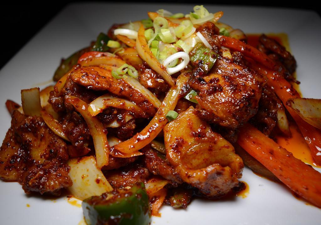 Spicy Stir-Fried Pork · Thinly sliced pork with onions, cabbage, and carrots in our Korean hot pepper paste sauce.