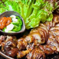 Marinated Pork Feet · Marinated overnight tender slices of pork feet with a side of lettuce wraps.