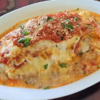 Lasagna Homemade · Lasagna with Tomato Sauce, Ground Meat Sauce, Mozzarella, Ricotta and Parmesan Cheese