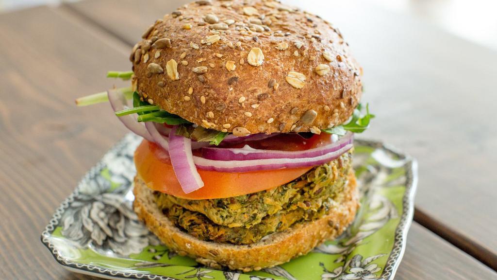 Harvest Veggie Burger  · Vegan. 100% organic. Beans, Butternut squash, zucchini, Beet, carrot,  sweet potato. Served on a bun with baby greens, sprouts, onions, tomatoes, shredded carrots and vegenaise. Harvest patty is vegan, gluten-free.