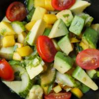 Mango Avocado Salad · Spring mix salad with mango, avocado, cucumbers, tomatoes, and citrus ponzu