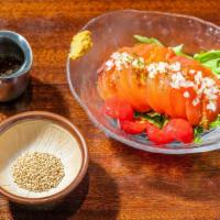 Tomato Salad  · Tomato topped with diced onions. Served with sesame and vinegar dressing.