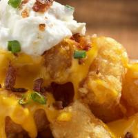 Lots-A-Tots · Tater tots covered in bacon, nacho cheese, sour cream, and green onions. 1310 cal.