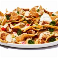 Tex-Mex Nachos Chicken · Tortilla chips layered with cheese, grilled chicken topped with shredded lettuce, pico de ga...