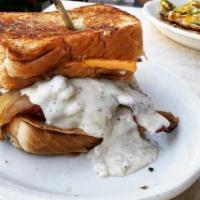 Country Mofo · Chicken patty, Ham, Fried egg & Sausage Gravy on two Texas Toast Grilled Cheese Sandwiches.