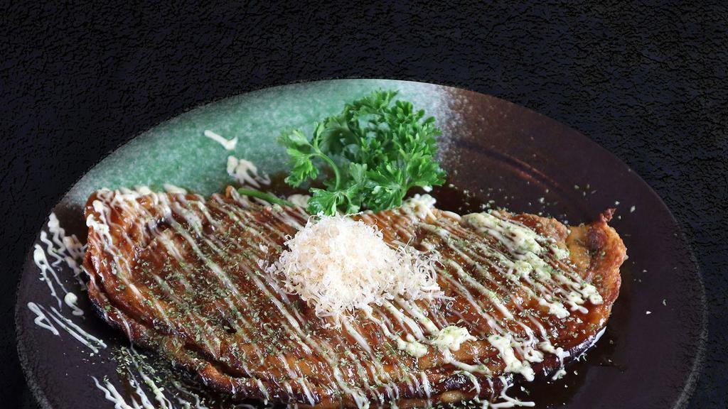 Fried Okonomiyaki · Japanese savory vegetable pancakes with sweet-savory sauce, mayo topped bonito flacks cheese, and egg.