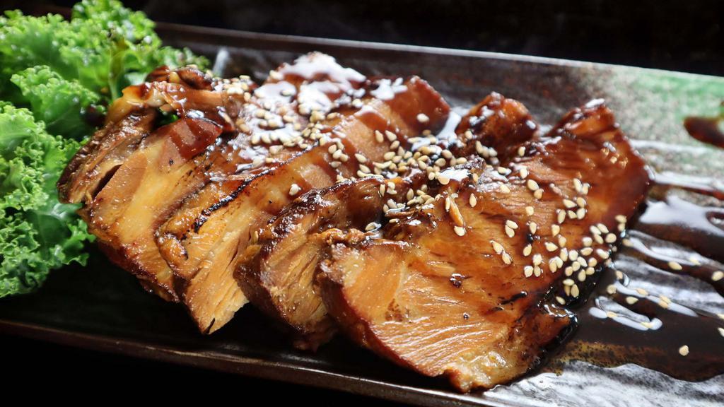 Pork Chashu (4Pcs) · Marinated braised pork belly with scallions, sesame seeds, and shoyu sauce.