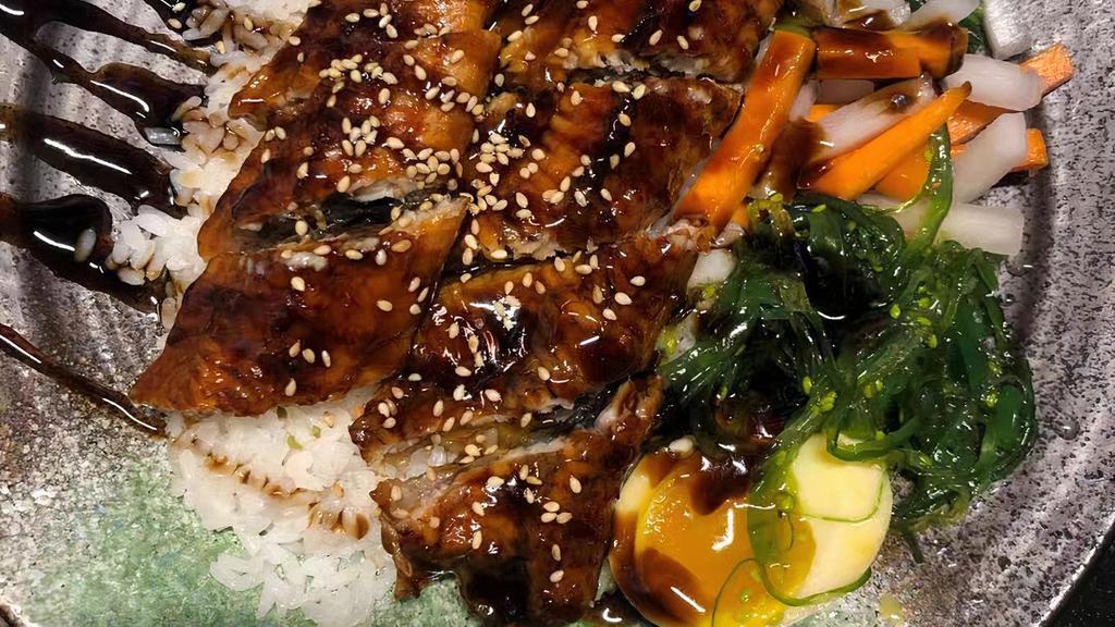 Unagi Don · eel, served over rice with seasoned egg, pickled , seaweed salad, spinach , scallions.