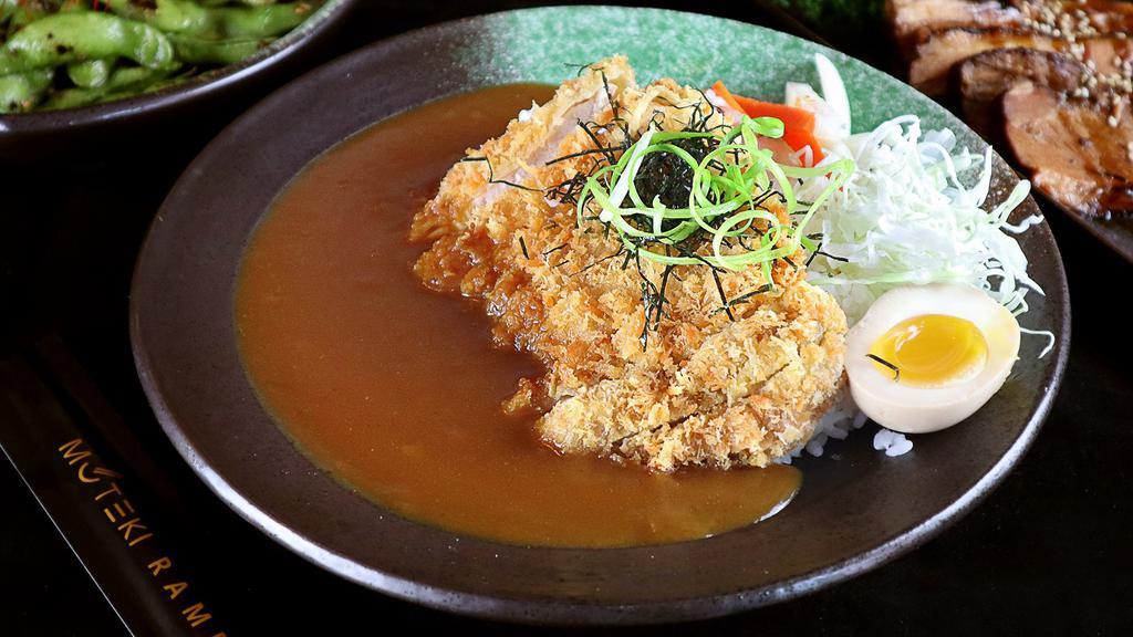 Pork Katsu Curry Don · Japanese juicy fried pork katsu, served over rice with seasoned egg, cabbage , scallions, furikake, nori, spicy paste, japanese curry.