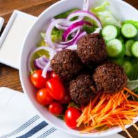 Falafel Salad Bowl · Served with falafel, lettuce, tomatoes, cucumbers, carrots & raw onions. Choice of dressing:...