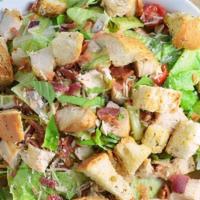Chicken Caesar Salad · Sliced grilled chicken breast over fresh romaine lettuce, premium croutons, shredded Parmesa...