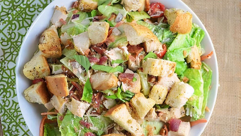 Chicken Caesar Salad · Sliced grilled chicken breast over fresh romaine lettuce, premium croutons, shredded Parmesan cheese, and Caesar dressing.